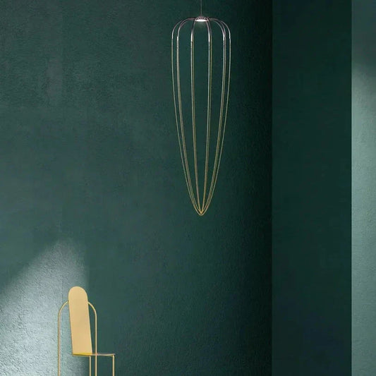 Axo Light Alysoid Pendant 51 Long with brass beads and a yellow chair in a green room