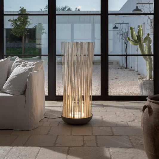 Don't Touch floor lamp by sofa on stone floor
