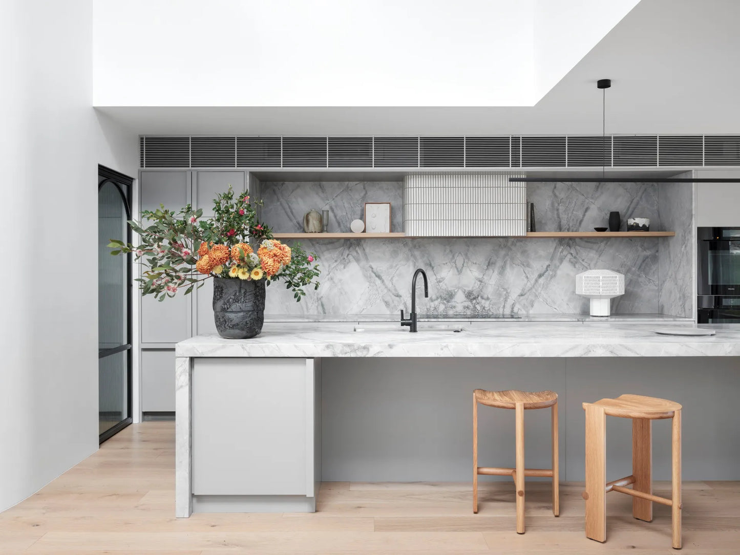 Highline Linear Pendant in Black over Kitchen Island with Sky Light