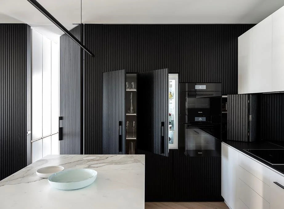 Highline Linear Pendant in Black over White Marble Kitchen Island with Black Cupboards