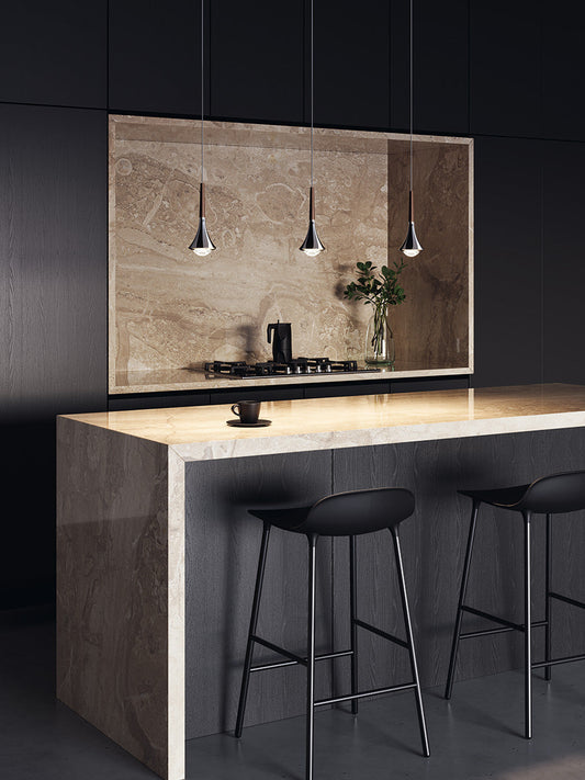Lodes Rain pendant in chrome with bronze stems shining downwards onto a marble kitchen island with black stools