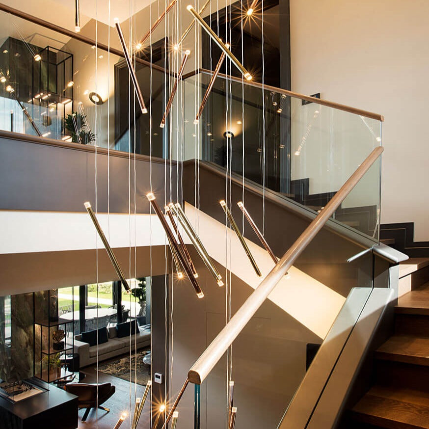 Lodes A-Tube Nano Duo chandelier in a staircase with wooden steps and a glass baulstrade