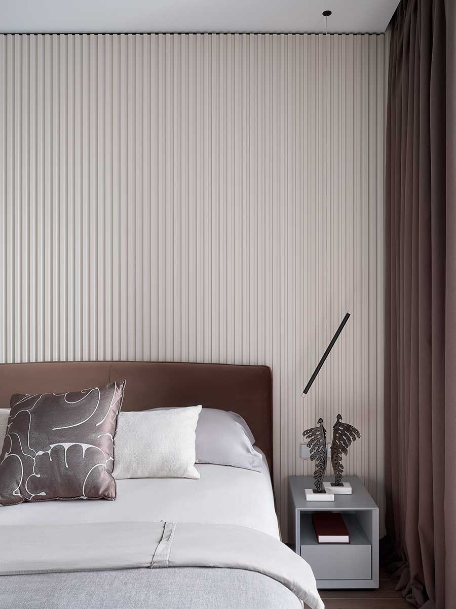 Lodes A-Tube Nano Duo pendant to the side of a bed