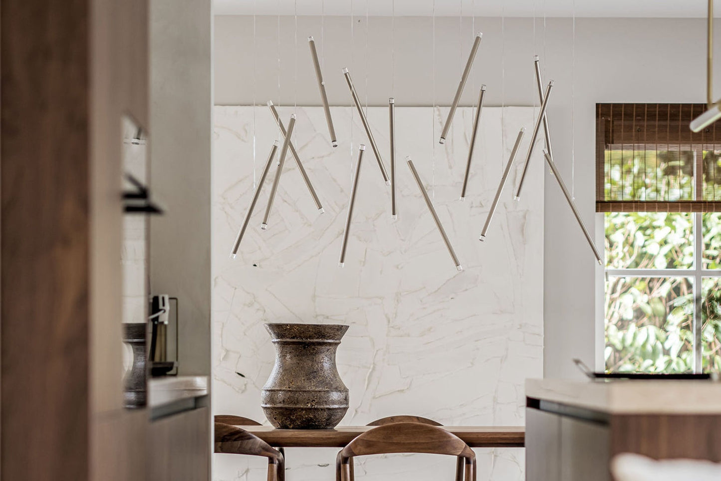 Lodes A-Tube Nano Duo hanging over a wooden dining table
