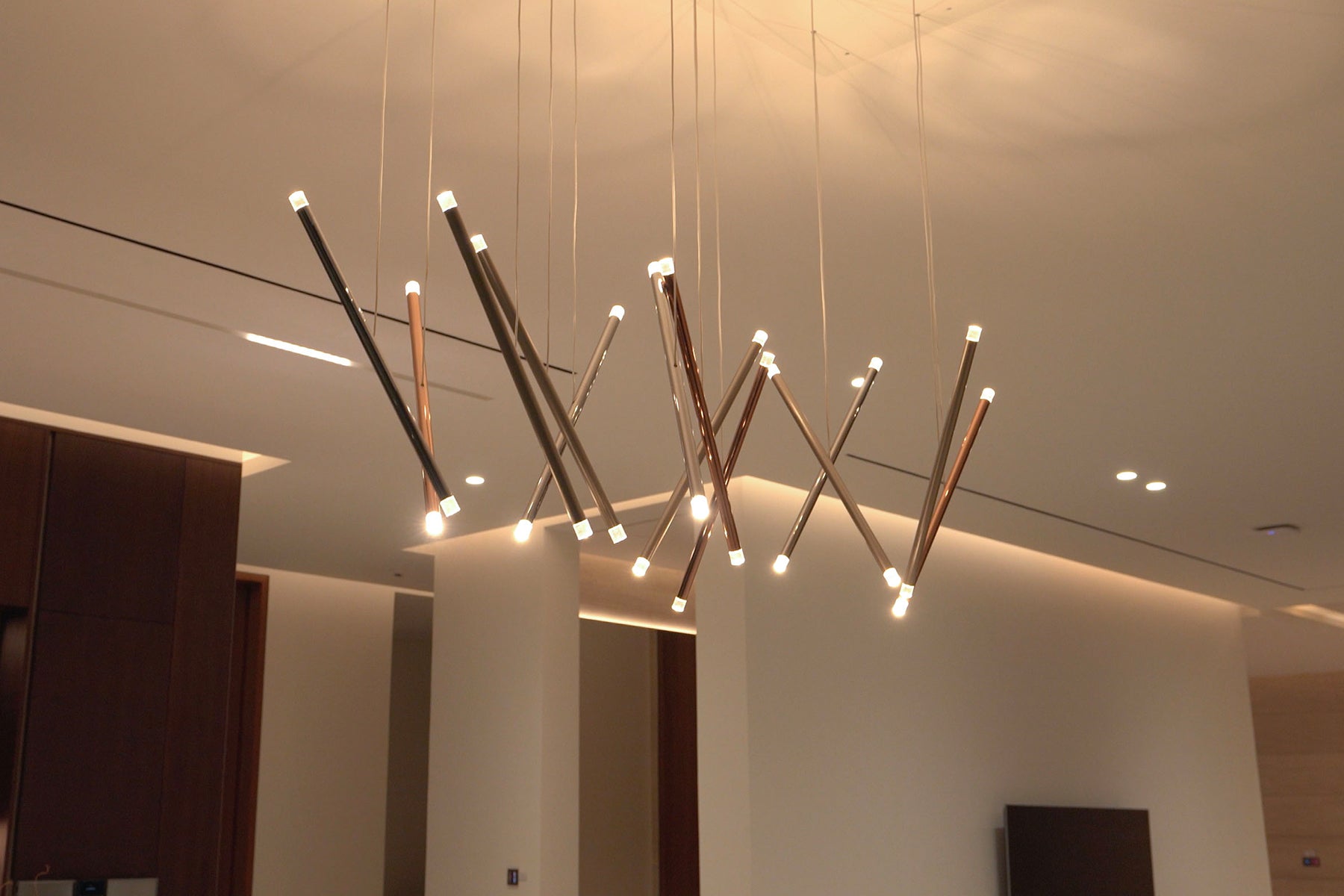 Lodes A-Tube Nano Duo pendants in a rectangular formation in a modern home