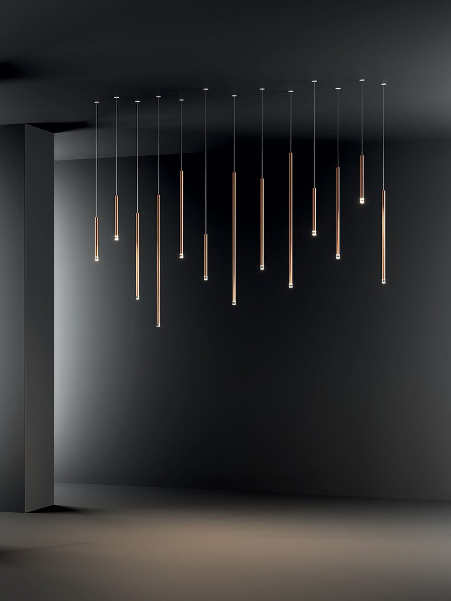 Lodes A-Tube Nano pendant with different sizes with a dark background