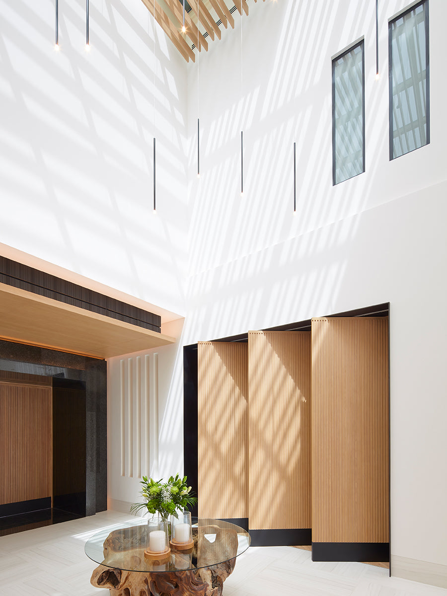 Lodes A-Tube Pendant in black in large atrium