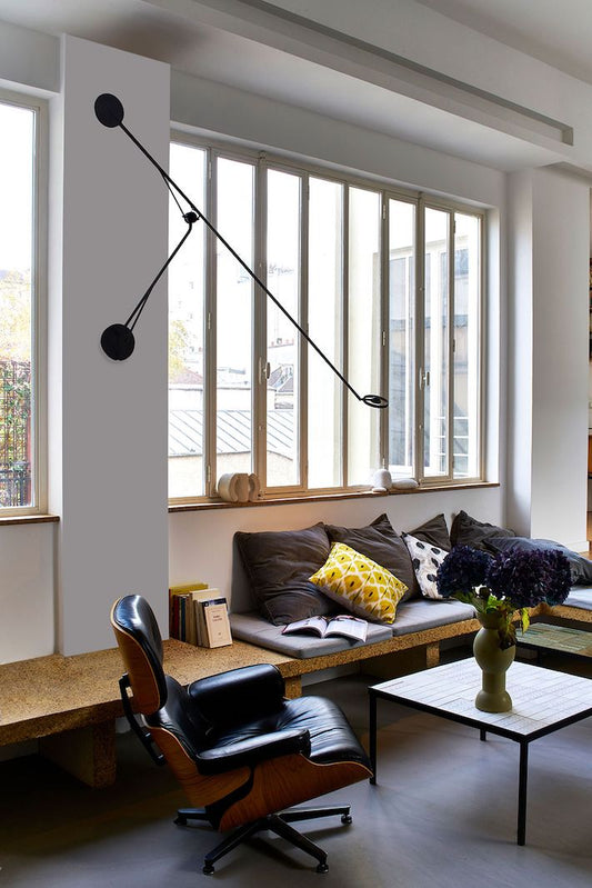 DWC Editions Aaro wall light over built-in seating in lounge with Eames chair
