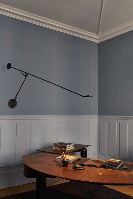 DWC Editions Aaro wall light over wooden desk with catalogues