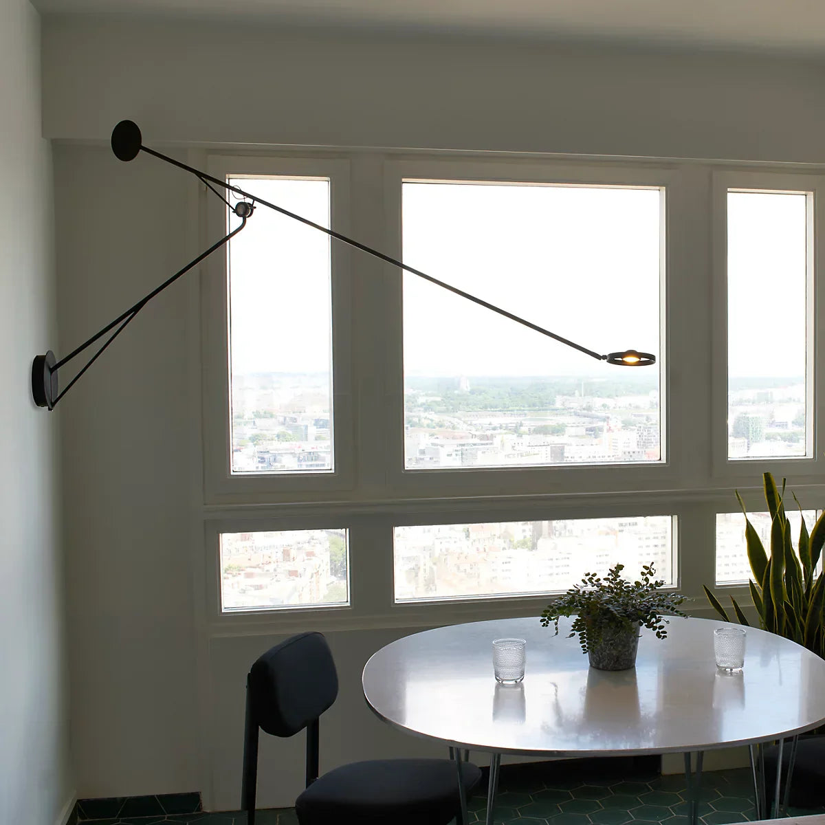 DWC Editions Aaro wall light over small, round dining table