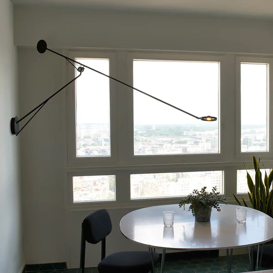 DWC Editions Aaro wall light over small, round dining table