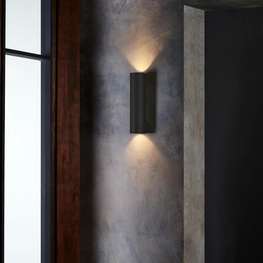 Modern wall-mounted light fixture on a textured wall.