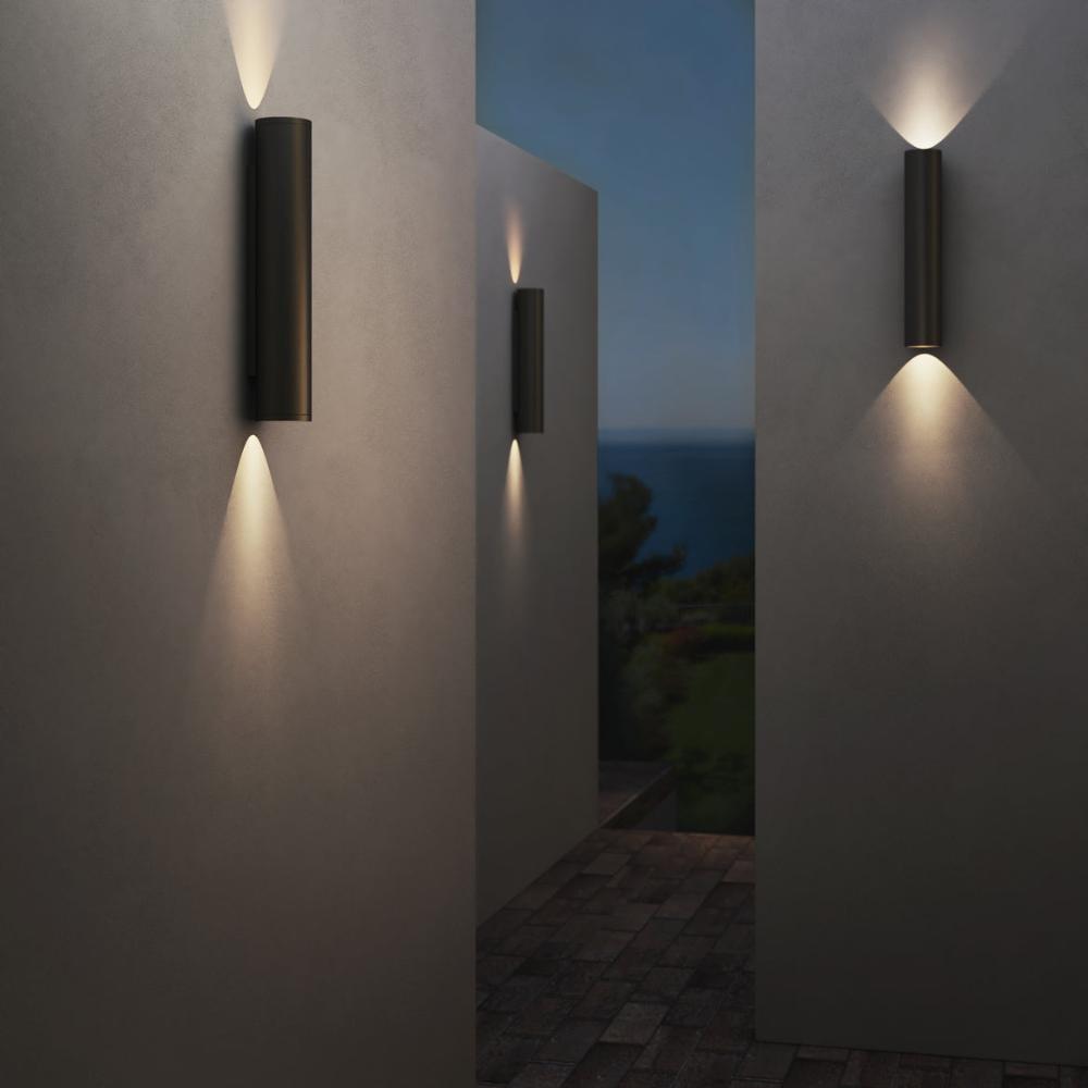 Modern outdoor wall lights on a building with a night sky and ocean view.