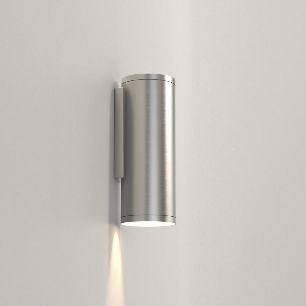 Metallic wall-mounted light fixture on a plain background