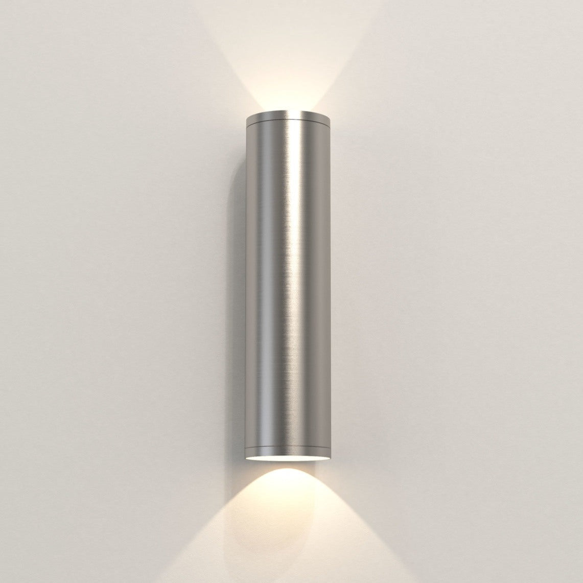 Cylindrical wall light fixture on a plain wall
