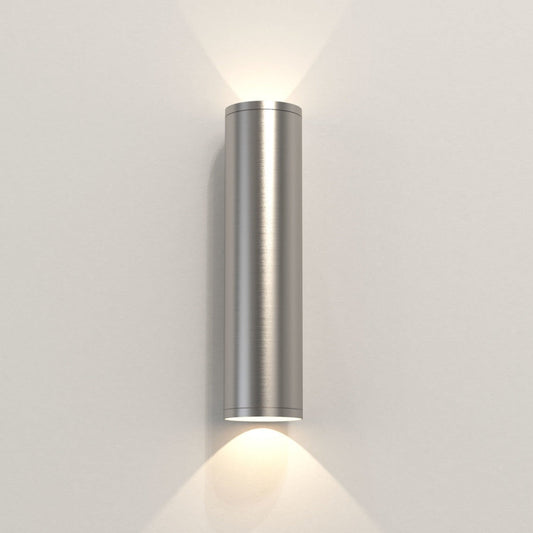 Cylindrical wall light fixture on a plain wall