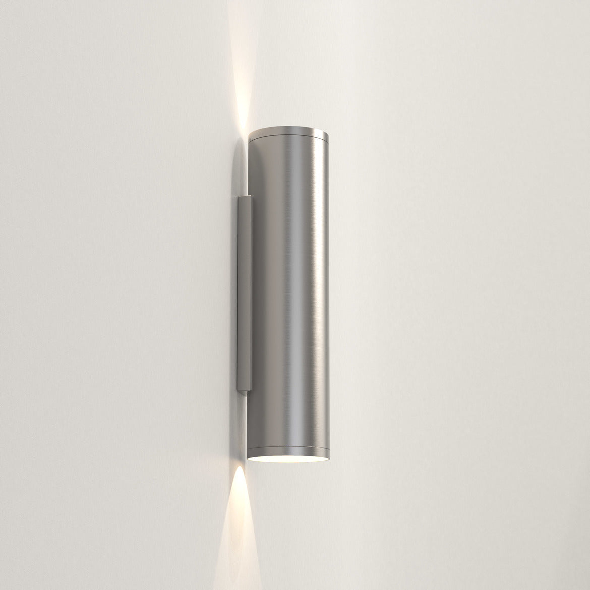 Cylindrical wall light fixture on a plain background