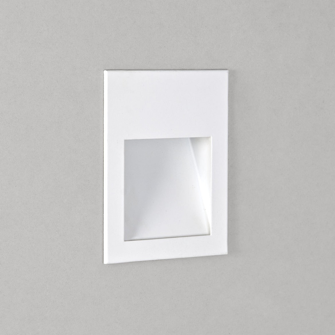 Square recessed light fixture on a gray wall