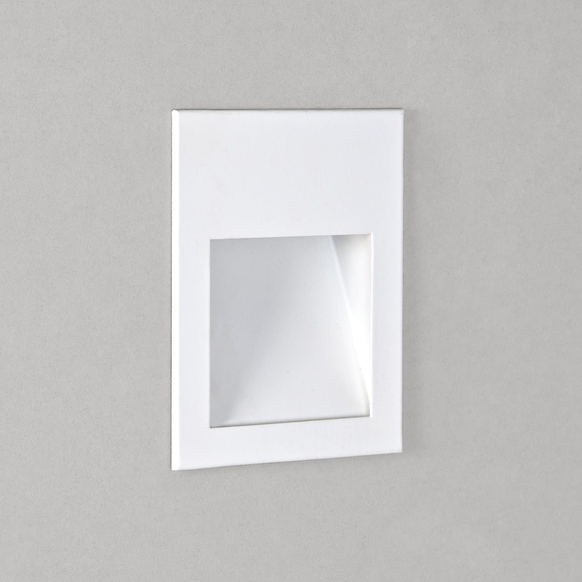 Square mirror with white frame on a gray background