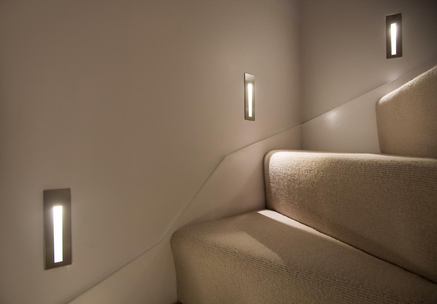 Staircase with wall lights on a neutral background