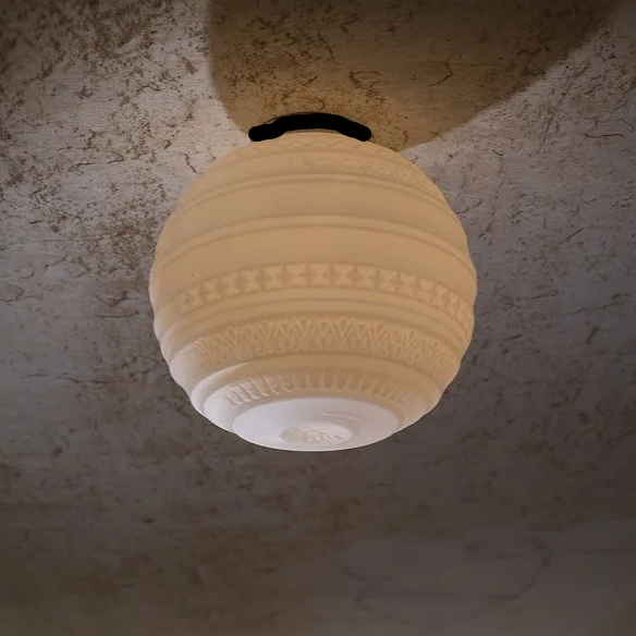 Decorative ceiling light fixture on a textured wall