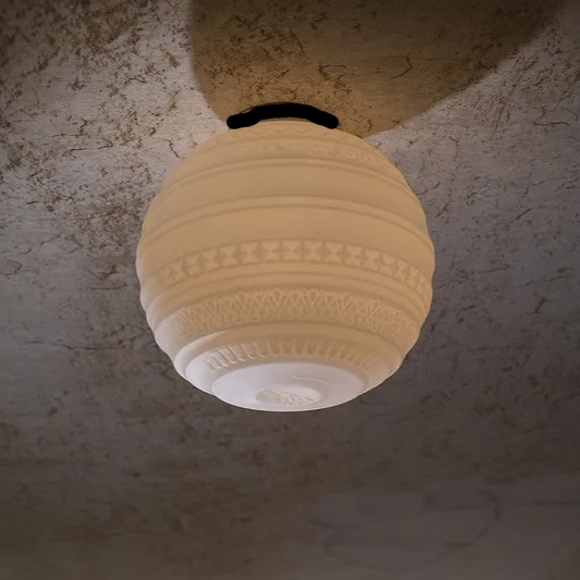 Decorative ceiling light fixture on a textured wall