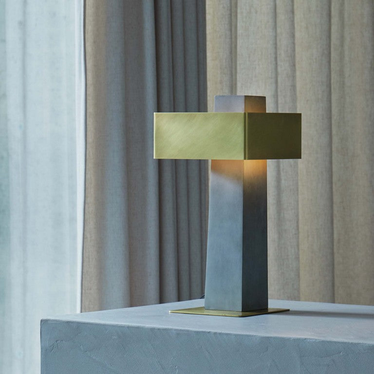 DCW Editions Iota table lamp in brass and bronze in room with beige curtains