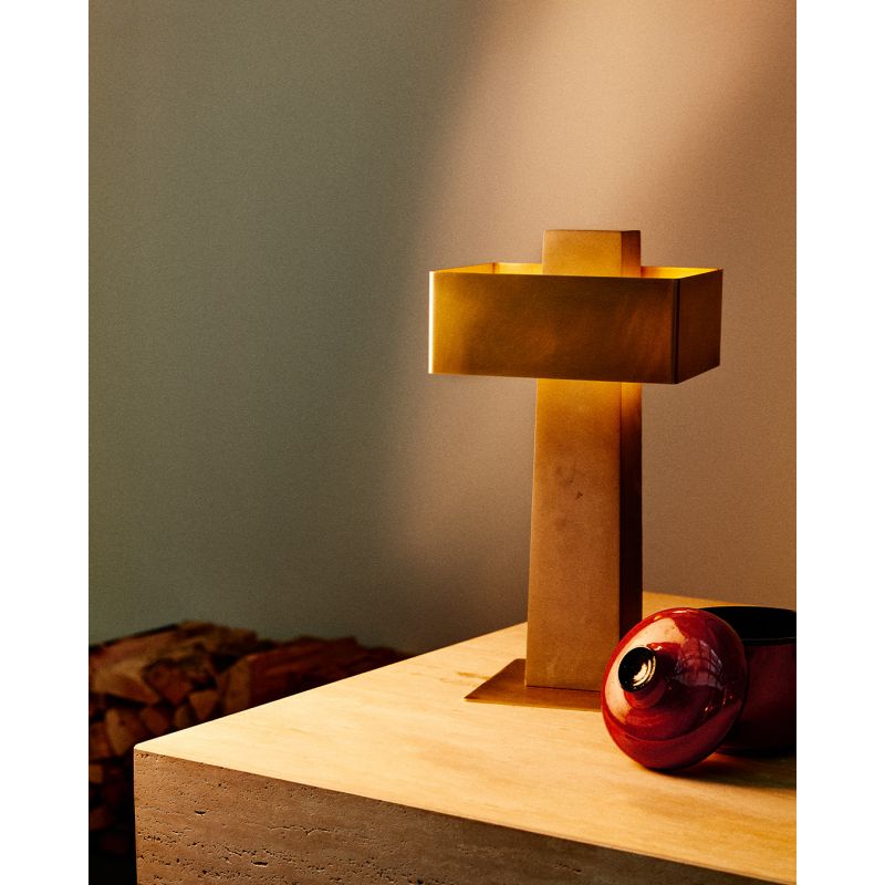 DCW Editions Iota table lamp in brass and bronze on wooden table with red object