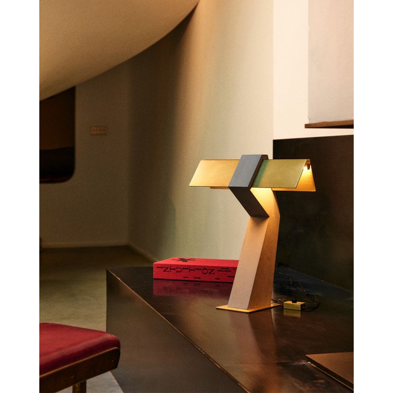 DCW Editions Iota table lamp in brass and bronze on console table with red box