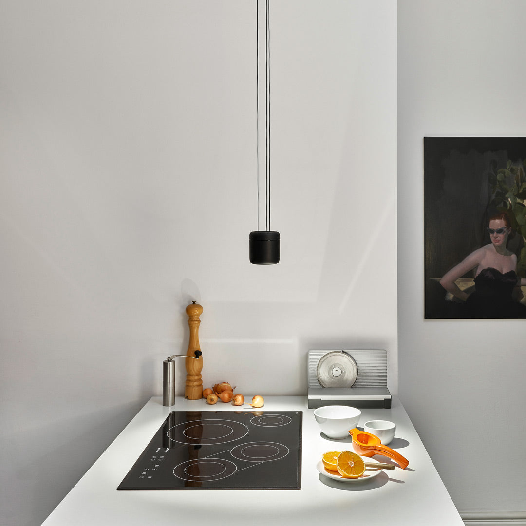 Cavity Pendant in Black Over Minimal Kitchen Hob Lit