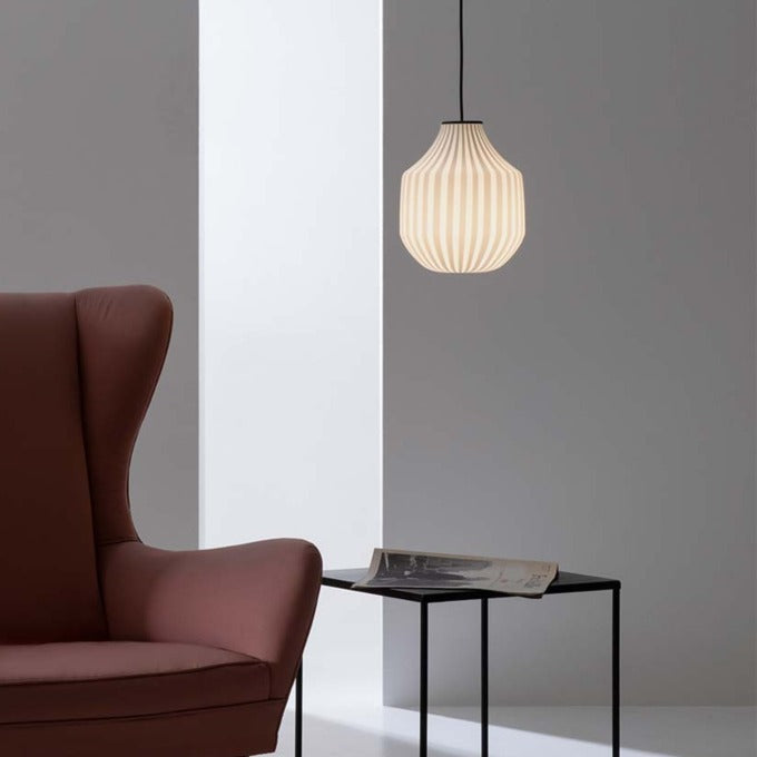 Karman Italia round Circus pendant over side table by rust coloured sofa close up