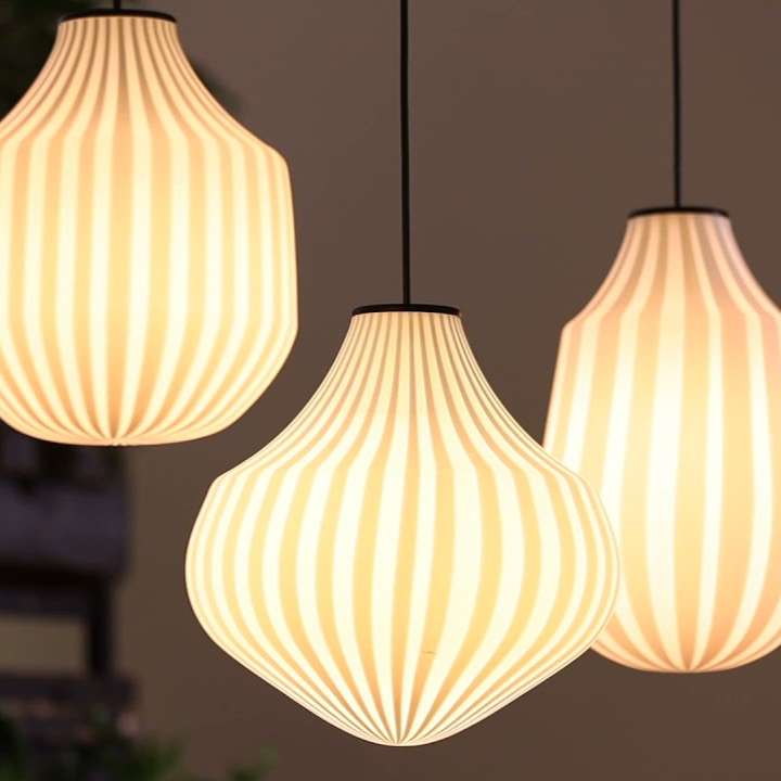 Karman Italia Circus pendant lights illuminated in a group