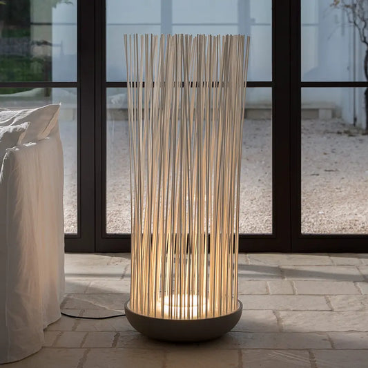 Don't Touch floor lamp by window on stone floor