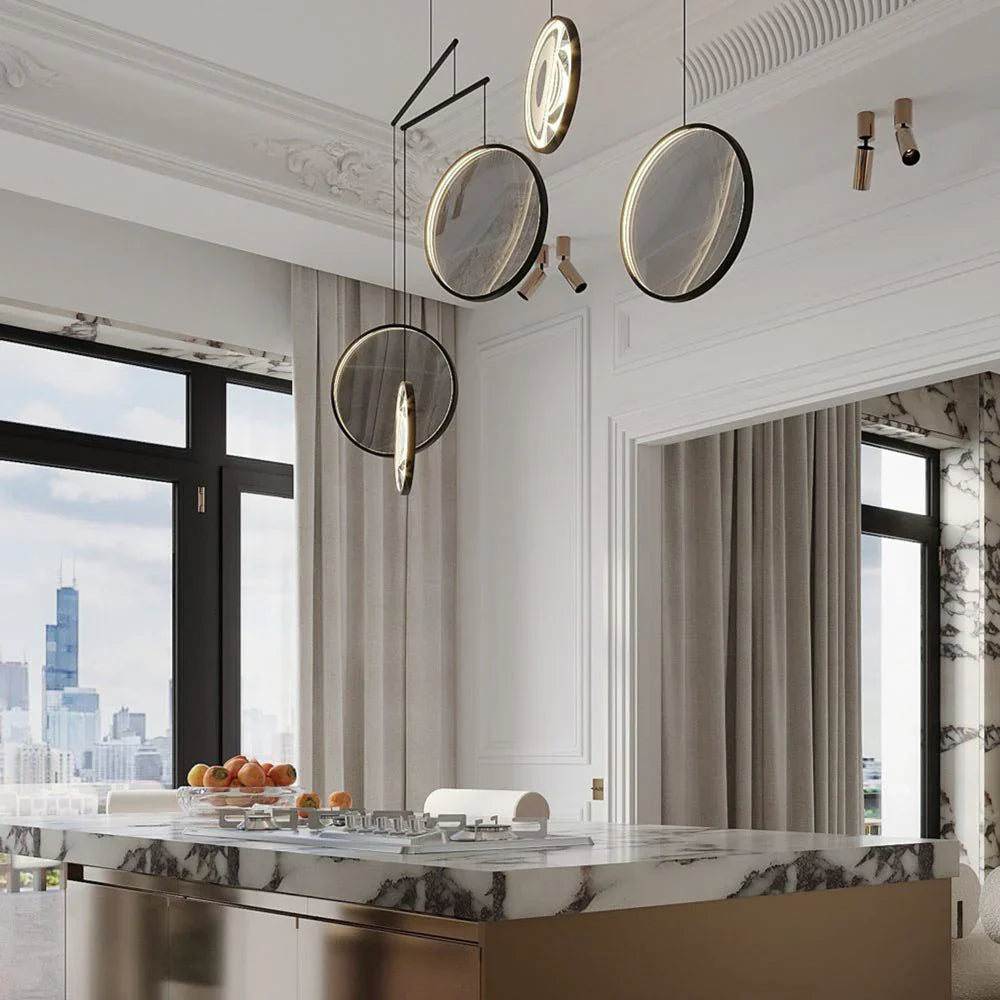 DCW Editions black Focus pendant with 5 circles over marble kitchen island with spot lights above