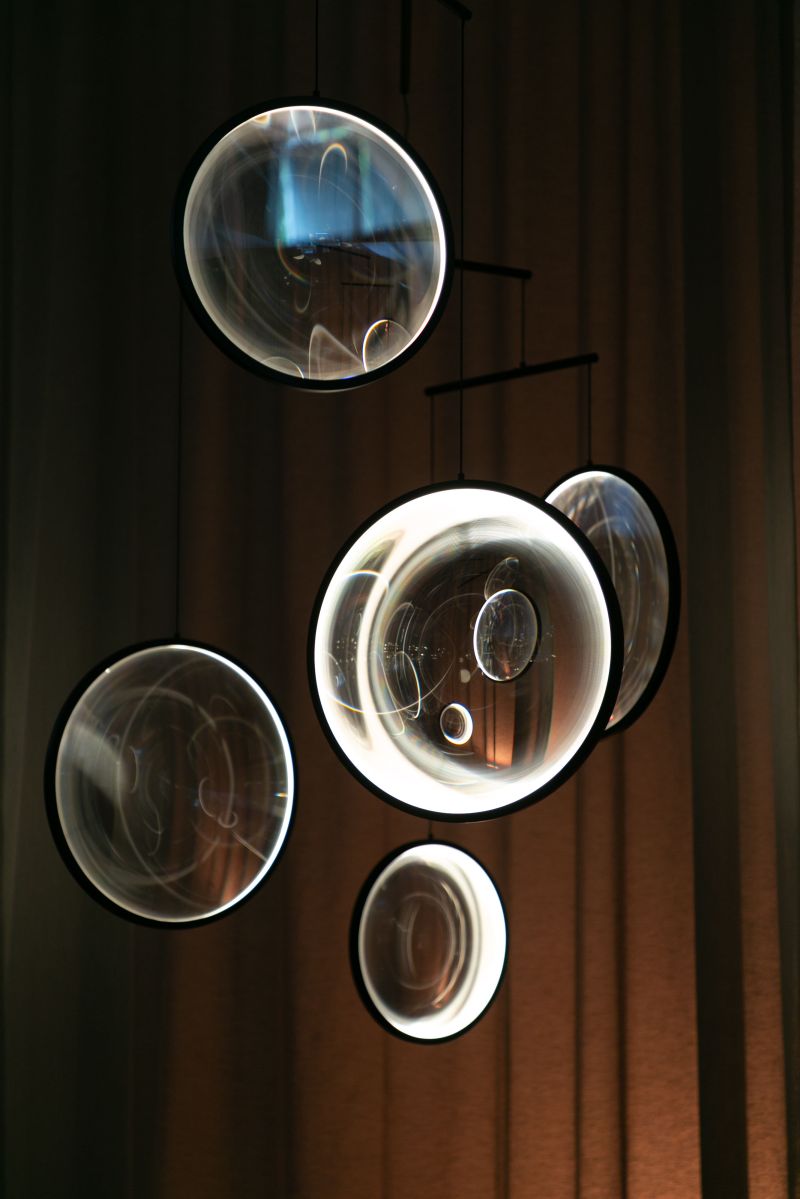 DCW Editions black Focus pendant with 5 circles with wooden background