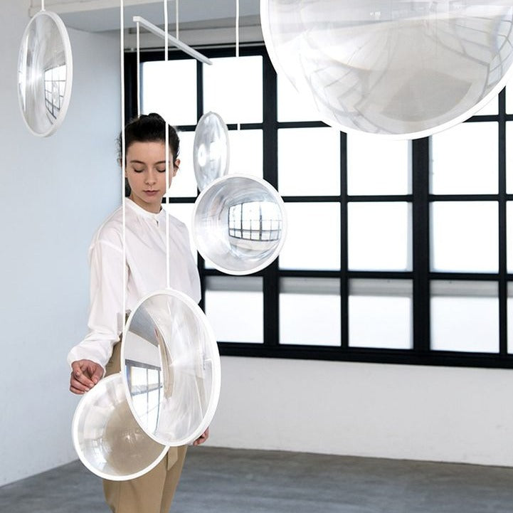 DCW Editions white Focus pendant with 5 circles in white room with woman and window
