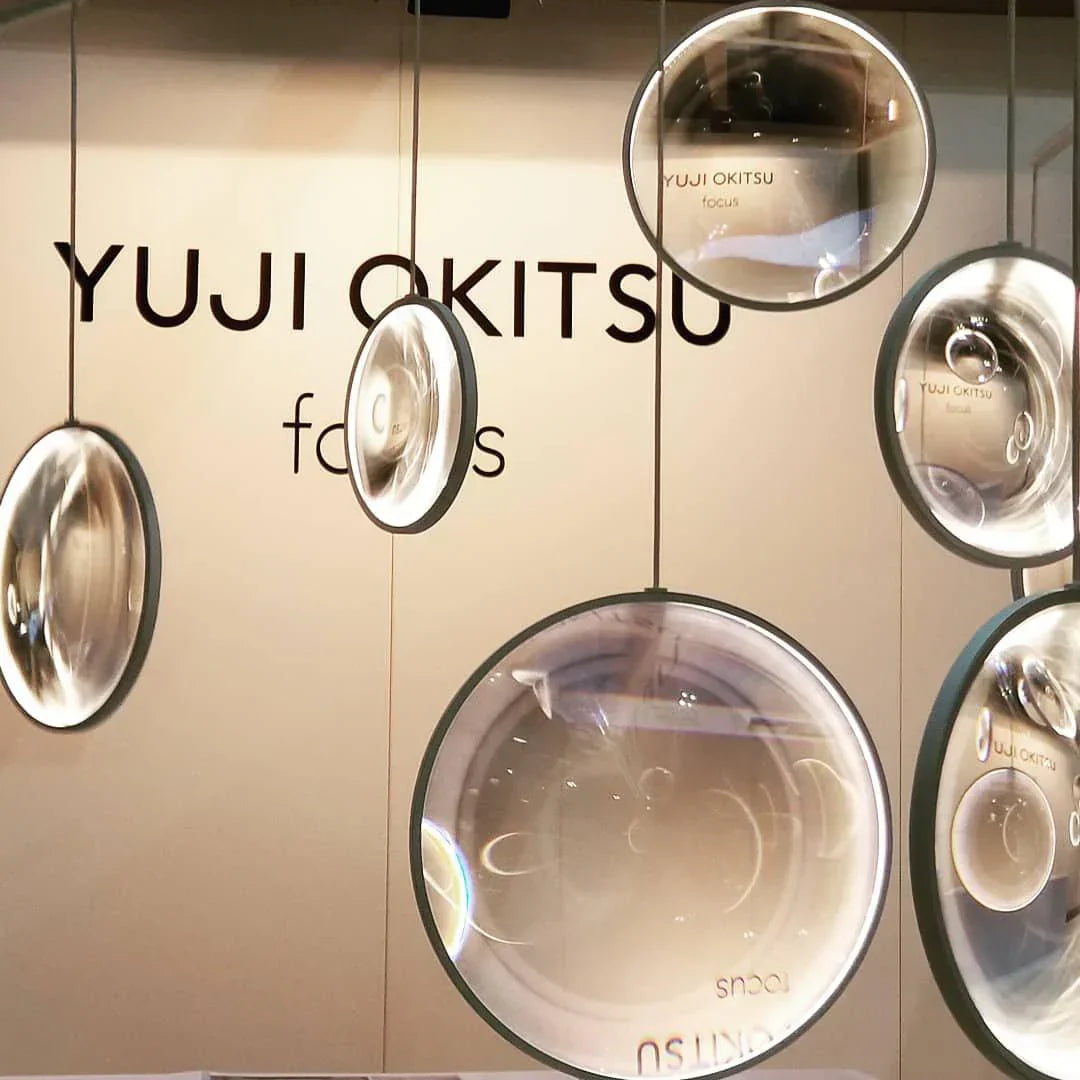 DCW Editions black Focus pendant with 5 circles on background with YUJI OKITSU text