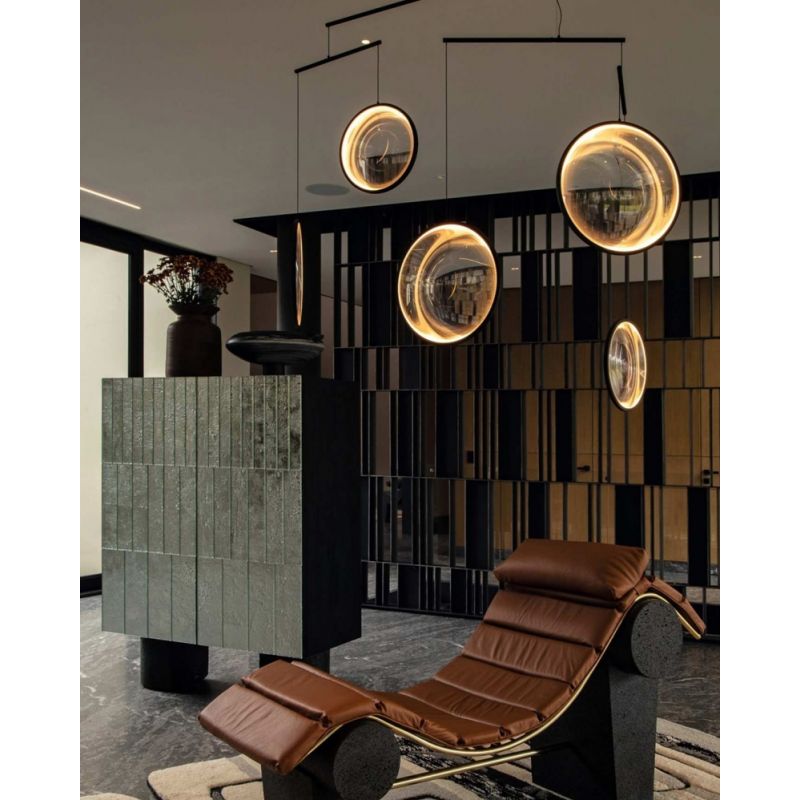 DCW Editions black Focus pendant with 4 circles over leather lounger in modern room