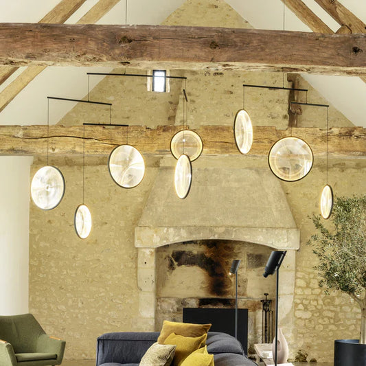DCW Editions black Focus pendant lounge with stone wall and wooden beams