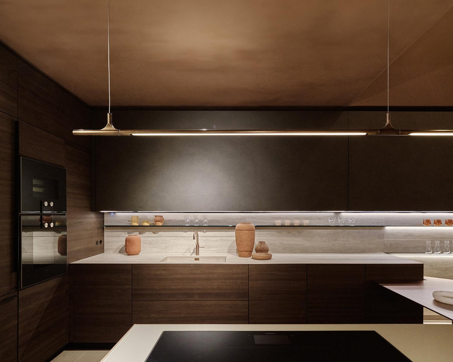 Modern kitchen with dark wood cabinets and a sleek design.