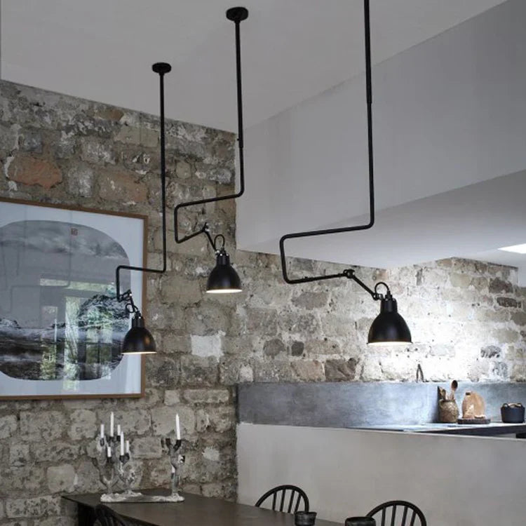 Gras-N312-Black-Pendant-Grouped-Over-Dining-Table-with-Stone-Wall