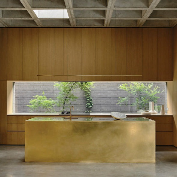 Highline Linear Pendant in Brass over Brass Kitchen Island with Linear Window