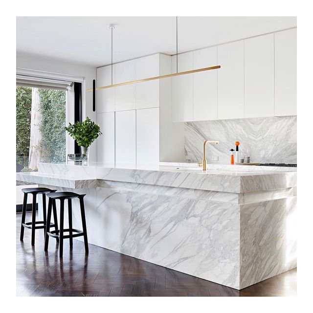 Highline Linear Pendant in Brass over White Marble Kitchen Island and Brass Tap