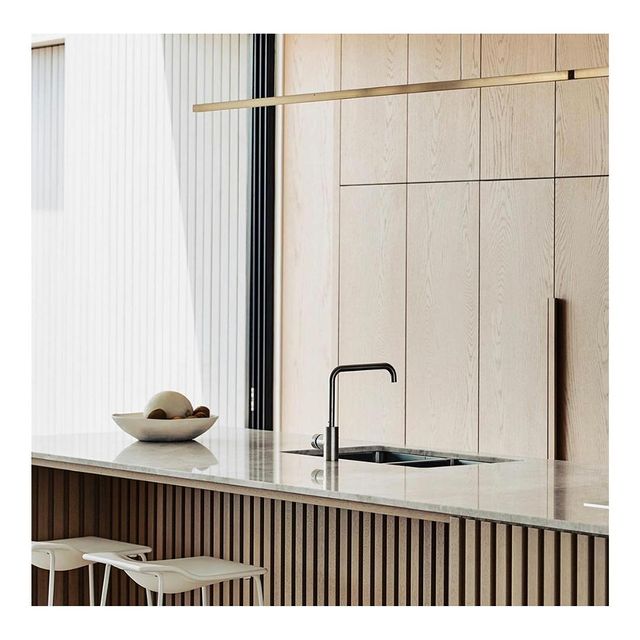 Highline Linear Pendant in Satin Brass over Kitchen Island with Wooden Slatted Base