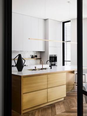 Highline Linear Pendant in Satin Brass with Black Vase on Kitchen Island