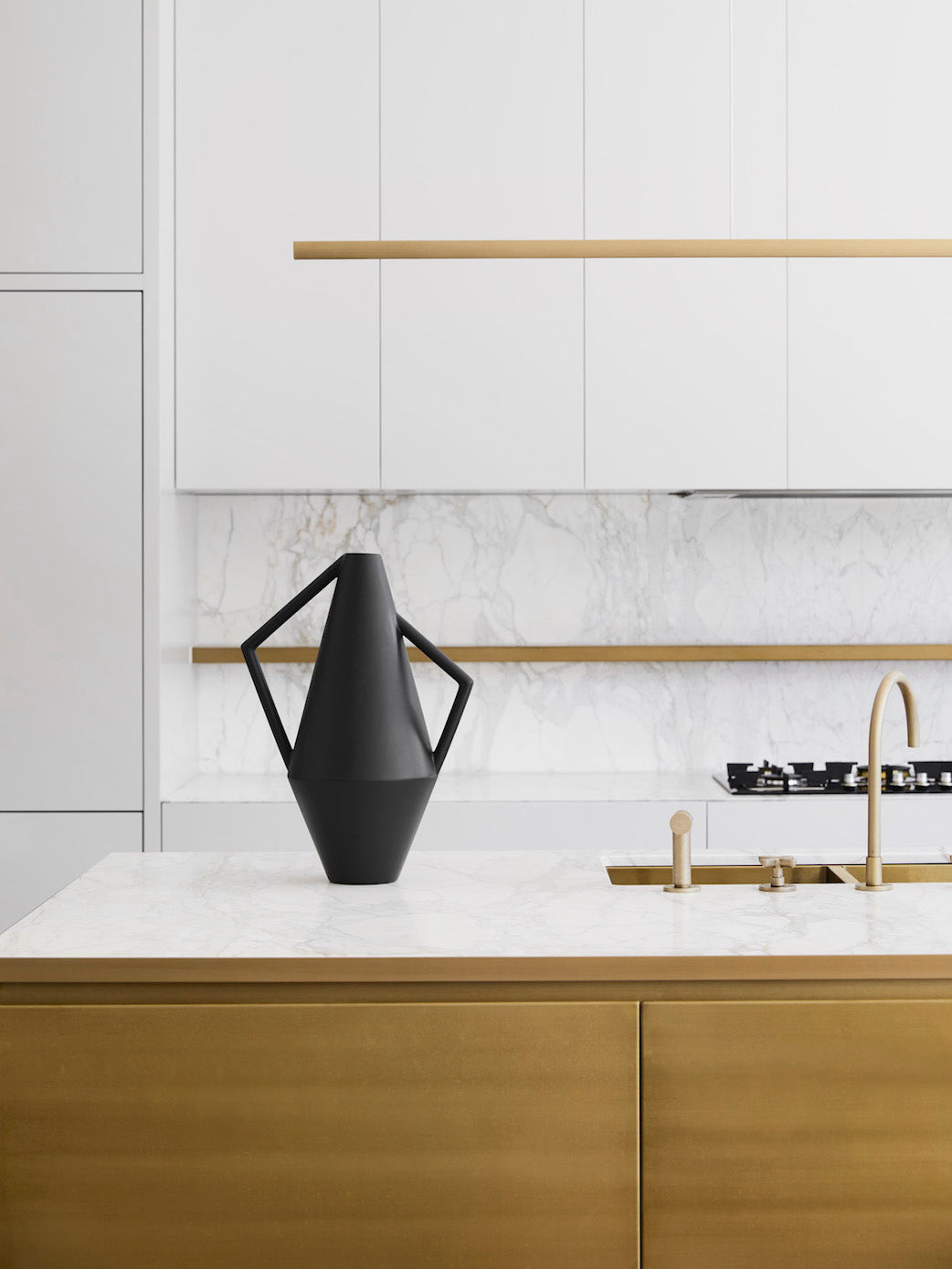 Highline Linear Pendant in Satin Brass with Black Vase over Kitchen Island