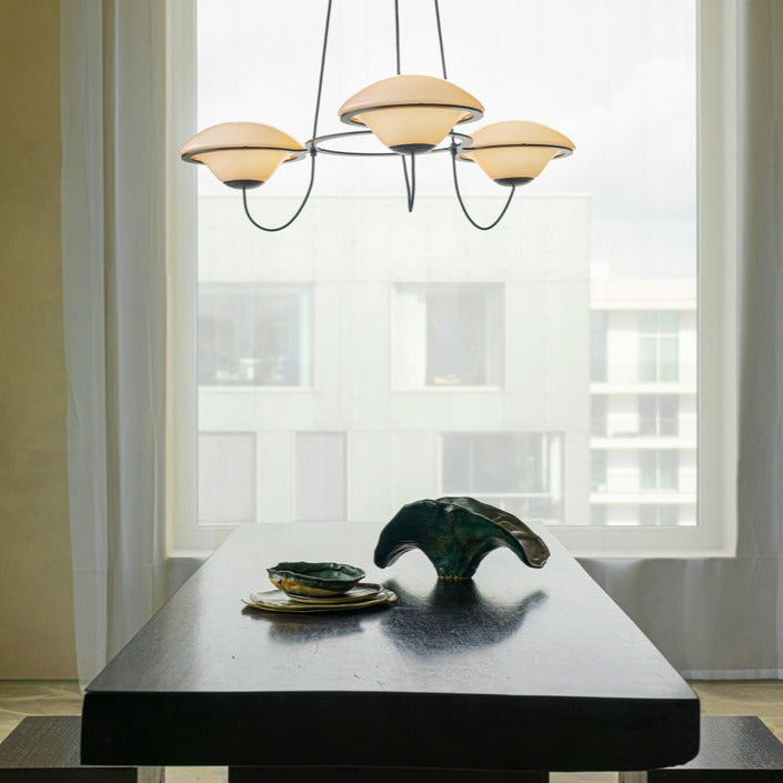 DCW Editions In The Air pendant with 3 shades over black table in front of window