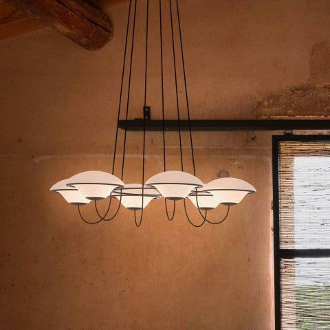 DCW Editions In The Air pendant with 5 shades in room with terracotta wall