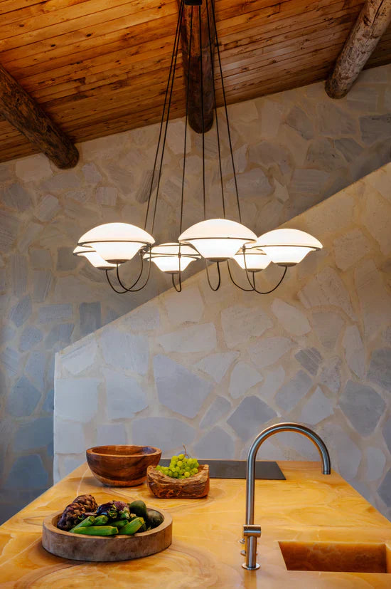 DCW Editions In The Air pendant with 5 shades over wooden kitchen island with wooden ceiling