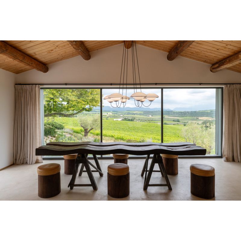 DCW Editions In The Air pendant with 5 shades over wavy wooden dining table